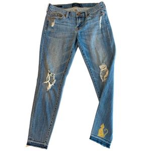 Lucky Brand with Cat embellishment. Distressed jeans. Size 4/27 Charlie Skinny